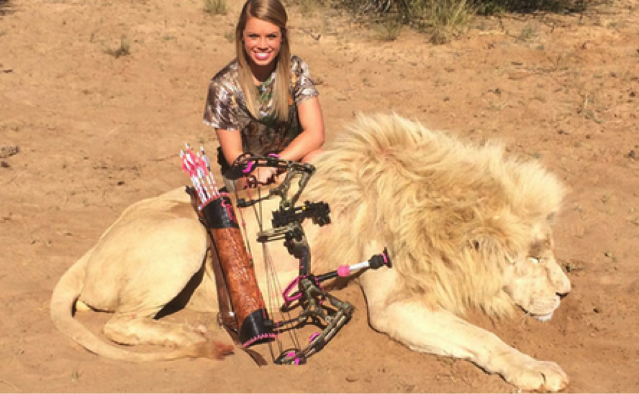 Kendall Jones posing with a lion she hunted and killed in Africa.